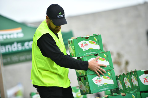 Phot of contestant stacking Zespri boxes